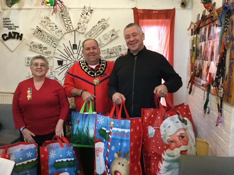 Handing over gifts for the homeless at Christmas